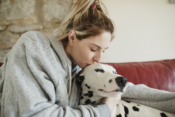 ragazza dà un bacio in fronte al cane