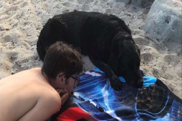 ragazzo al mare con un cane